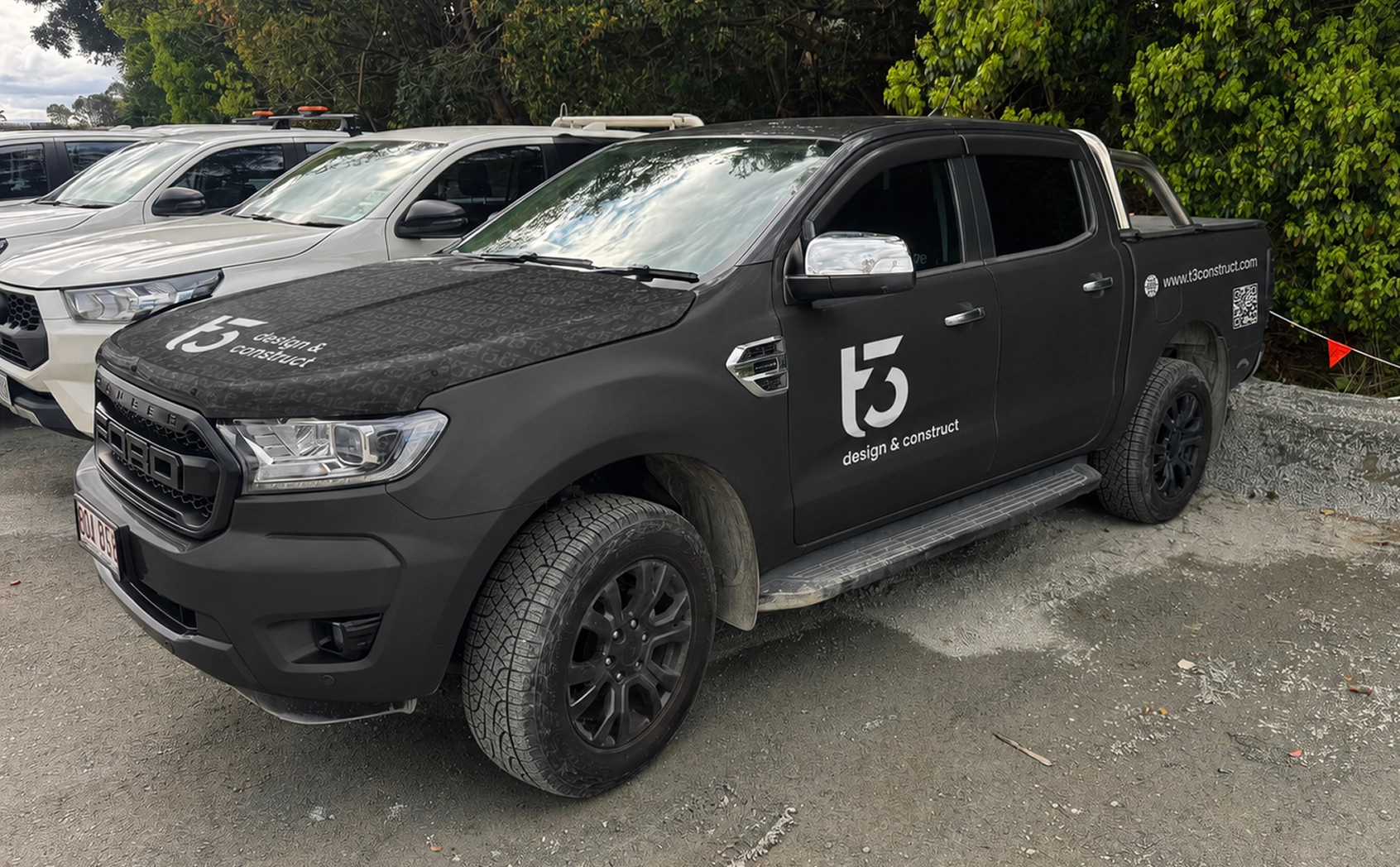 T3 Design & Construct branded Ford Ranger front angle parked among other vehicles outdoors