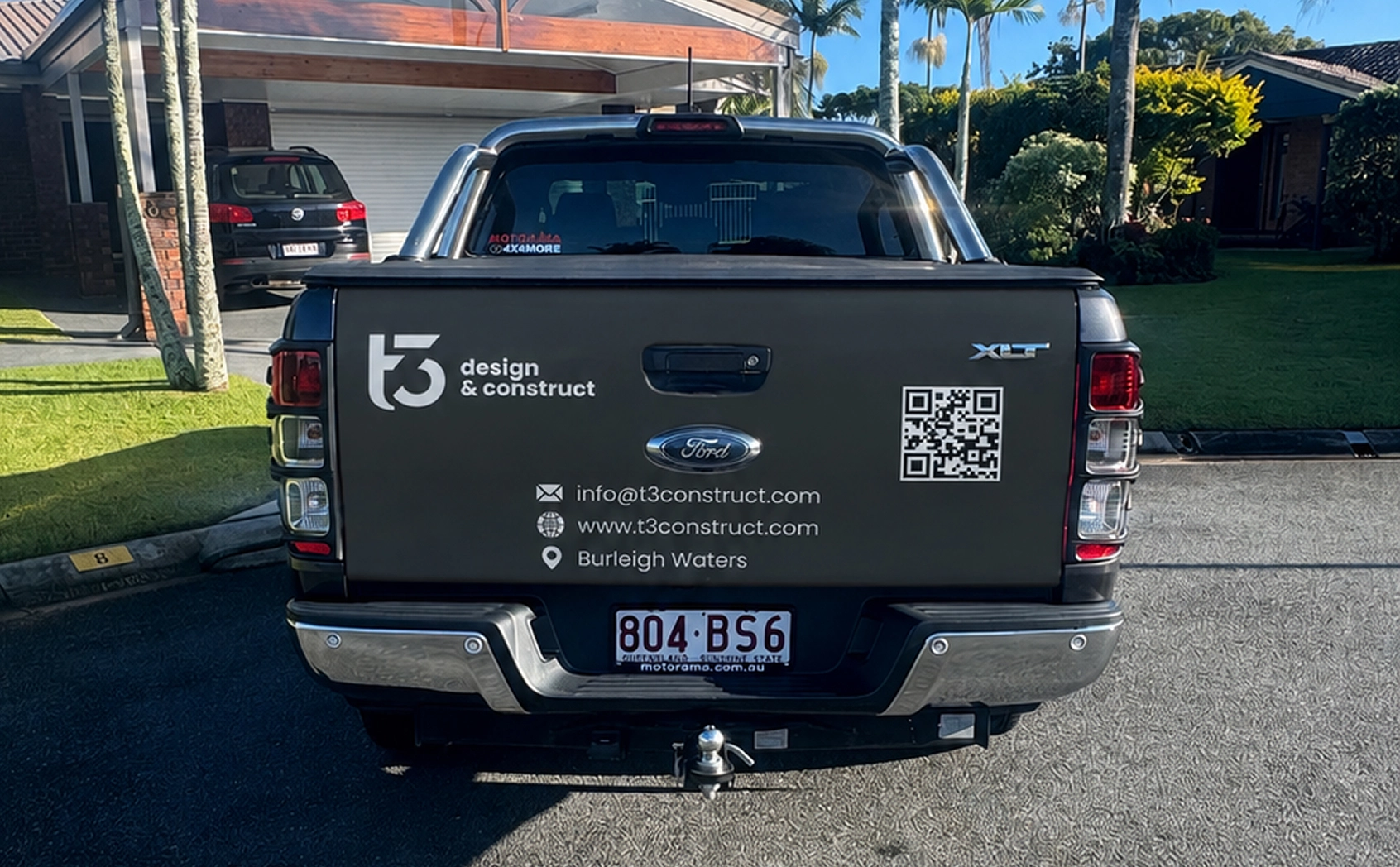 T3 Design & Construct branded Ford Ranger rear tailgate with contact details, parked in a client driveway